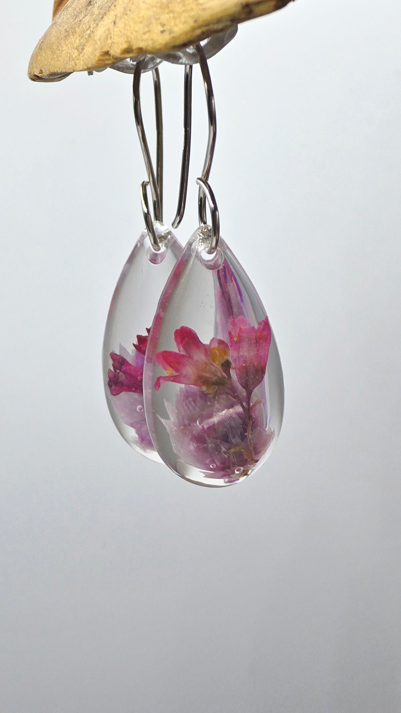 Earrings featuring wildflower specimens of Preserved Rhodanthe & Coral Bells, secured on a .925 Sterling Silver Hook