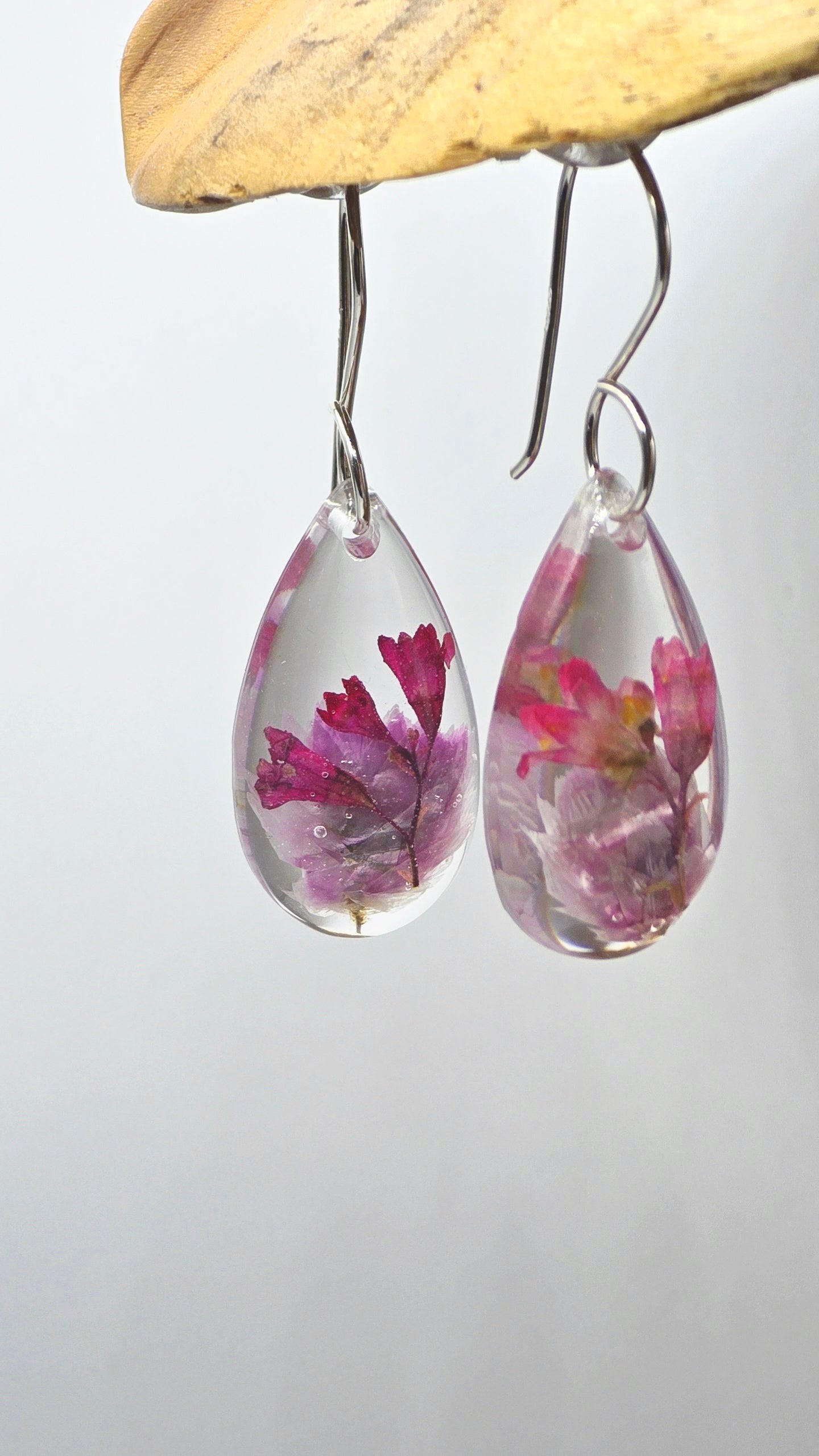 Earrings featuring wildflower specimens of Preserved Rhodanthe & Coral Bells, secured on a .925 Sterling Silver Hook