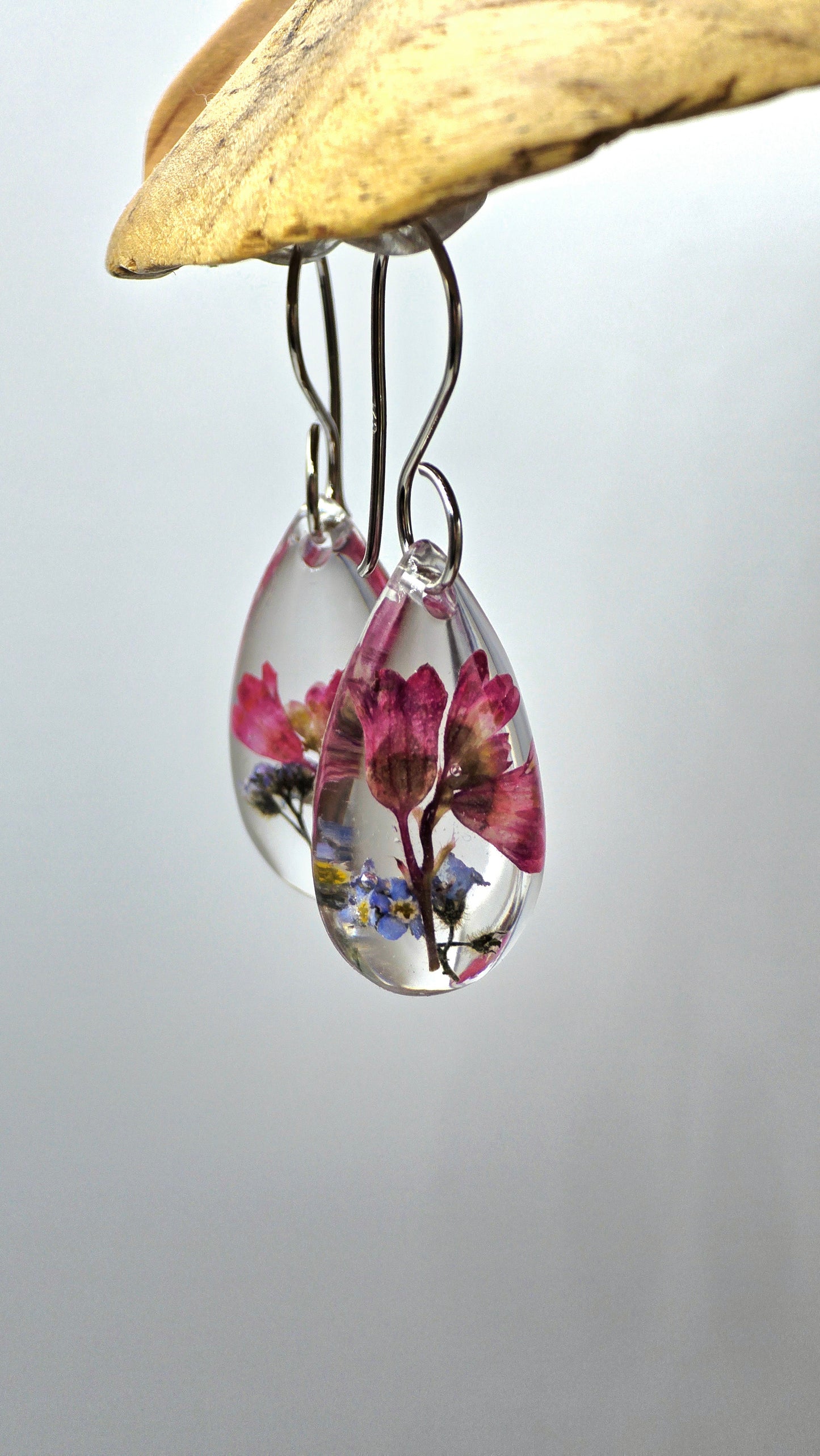 Earrings featuring wildflower specimens of Preserved Coral Bells & Forget-me-not, secured on a .925 Sterling Silver Shepherd Hook