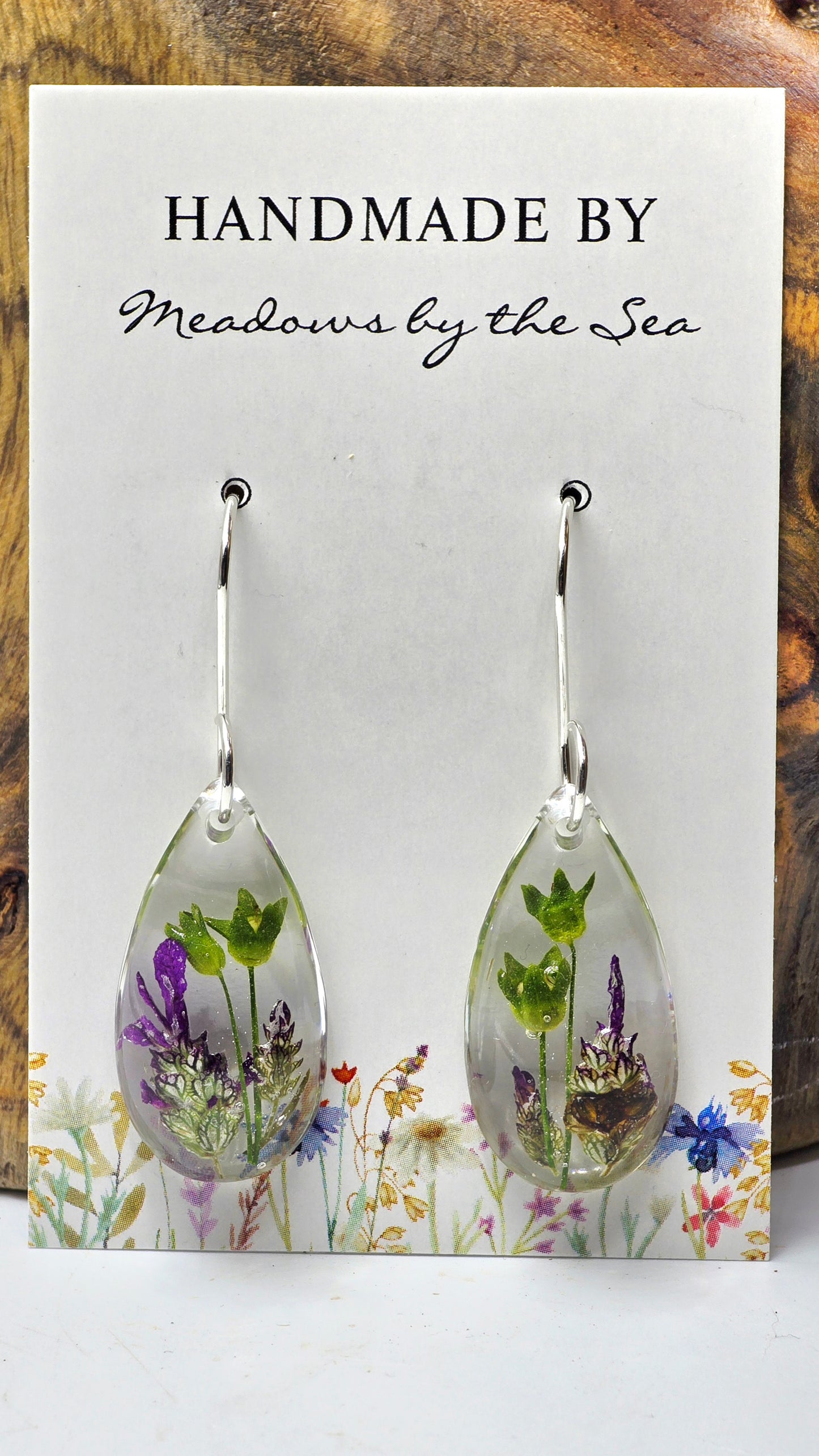 Earrings featuring wildflower specimens of Preserved Primula and Lavender, secured on a .925 Sterling Silver Shepherd Hook