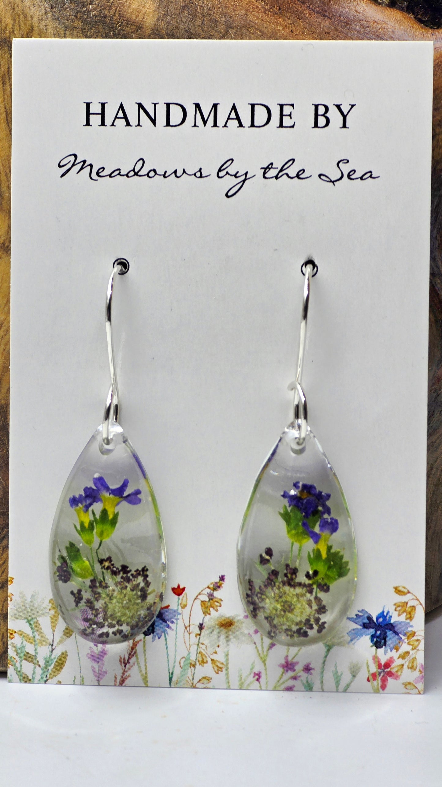 Earrings featuring wildflower specimens of Preserved Primula & Chocolate Queen Annes Lace, secured on a .925 Sterling Silver Shepherd Hook