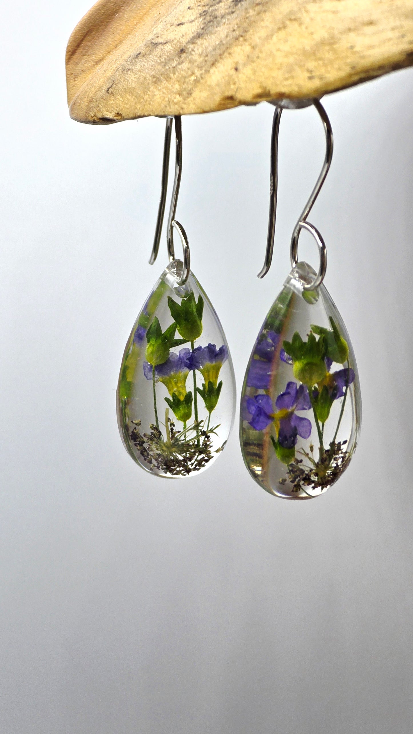 Earrings featuring wildflower specimens of Preserved Primula & Chocolate Queen Annes Lace, secured on a .925 Sterling Silver Hook