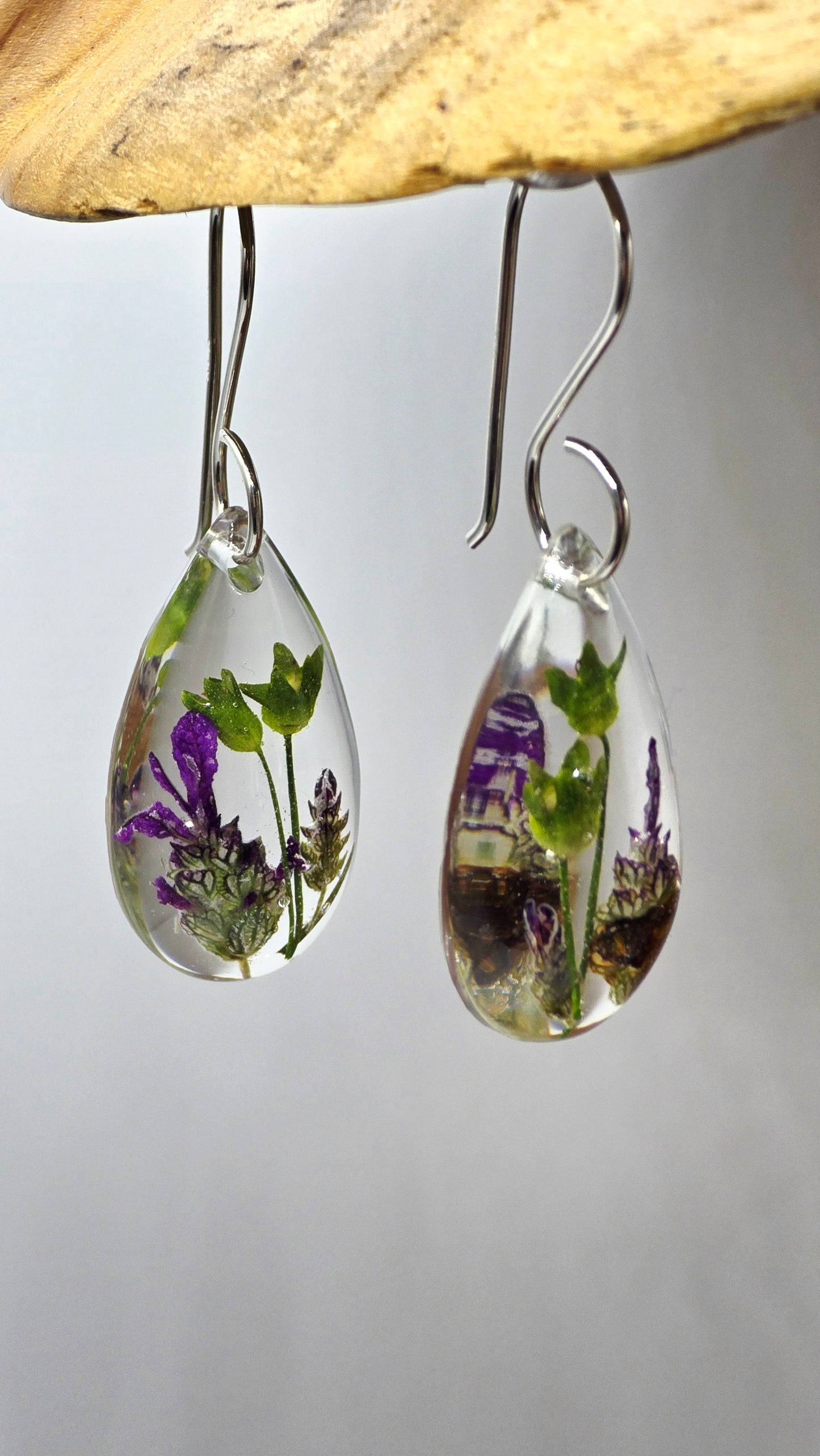 Earrings featuring wildflower specimens of Preserved Primula and Lavender, secured on a .925 Sterling Silver Shepherd Hook