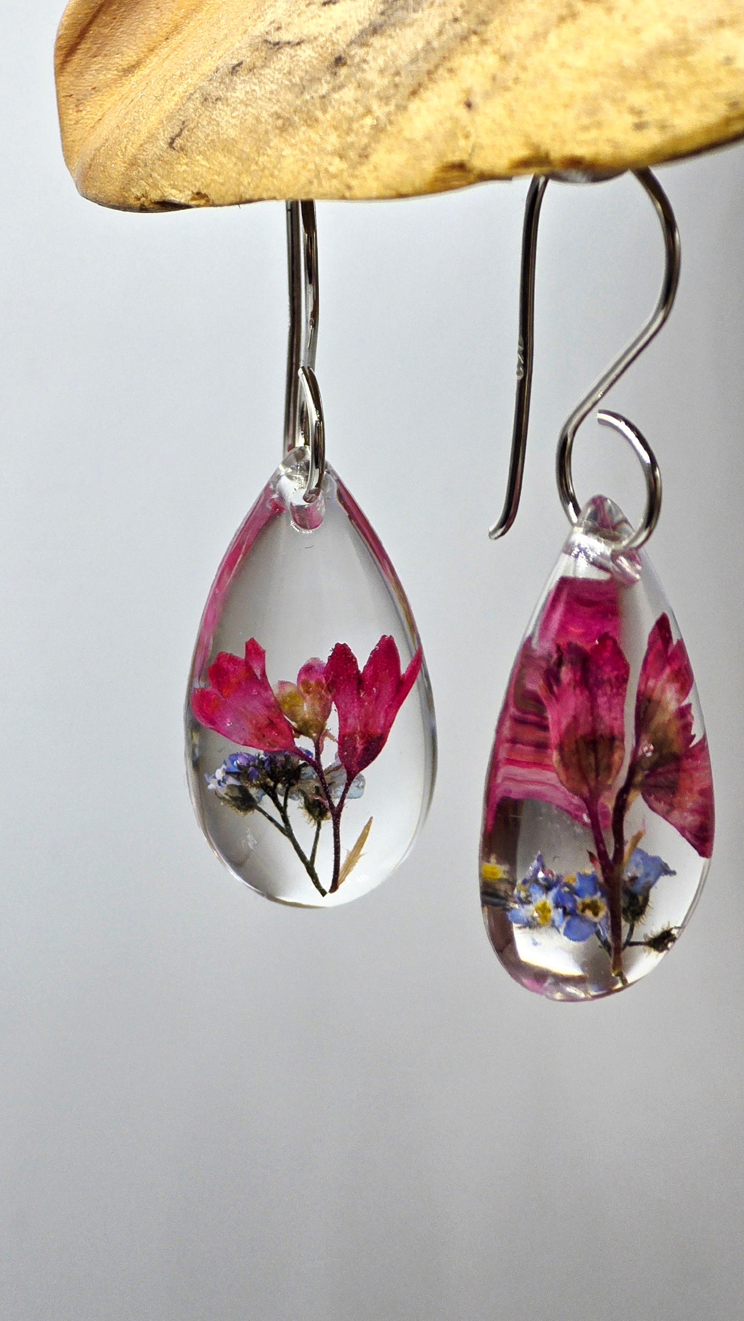 Earrings featuring wildflower specimens of Preserved Coral Bells & Forget-me-not, secured on a .925 Sterling Silver Shepherd Hook