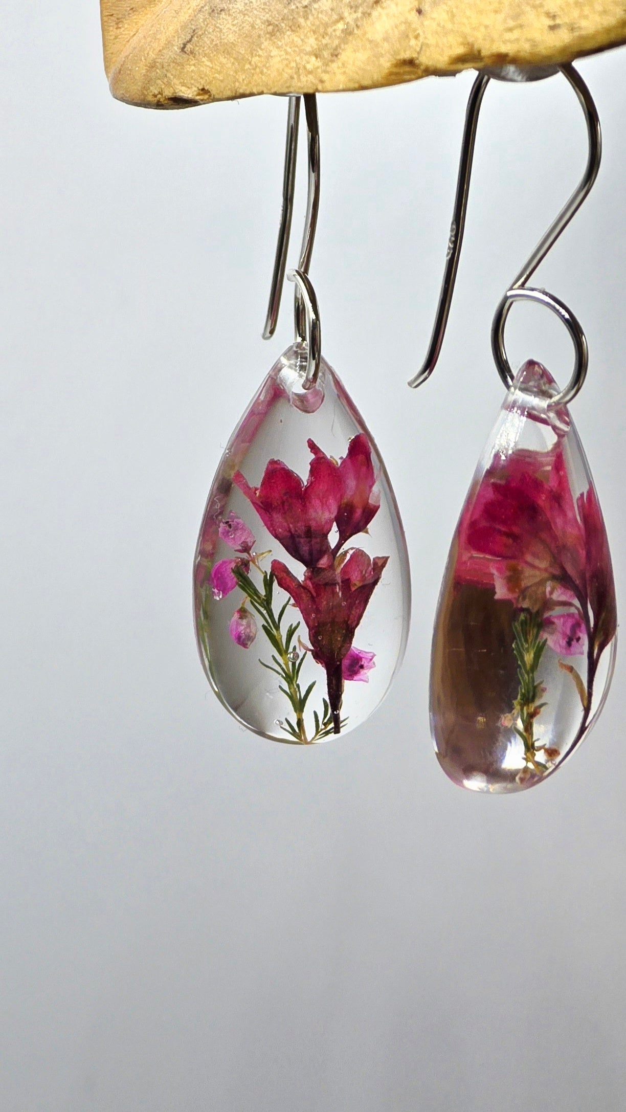 Earrings featuring wildflower specimens of Preserved Coral Bells & Heather Flower, secured on a .925 Sterling Silver Shepherd Hook